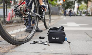 Cyclist prepares to fix flat tire with tools visible